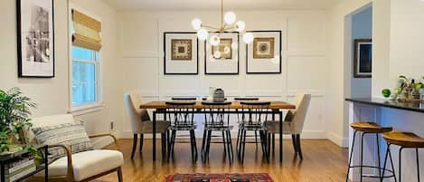 Eclectic Dining room with custom live edge table and modern lighting