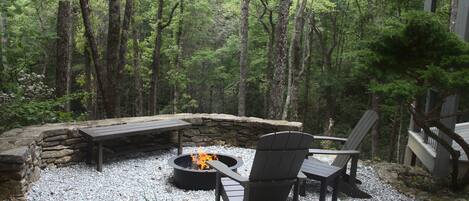 Fire pit at Hawk's Nest Retreat; beautiful sunset w/ hot tub right behind you. 