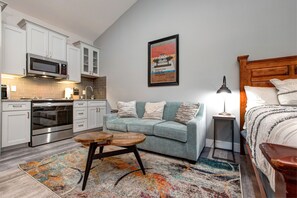 Cozy sofa bed and kitchen with a stylish center table.