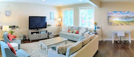 Bright and comfortable living room to relax and enjoy visiting; queen sofabed.