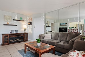 Expensive living room, facing kitchen and dining area, and patio.