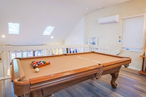 There's a pool table in the loft, which overlooks the living room.