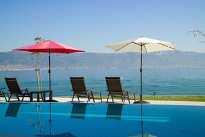 Deck chairs by the pool of Croatian private luxury vacation villa for rent and vacation at the beach on Ciovo