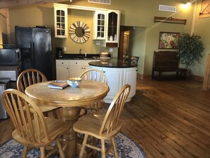 Eating area and kitchen - view to back hall with bedrooms