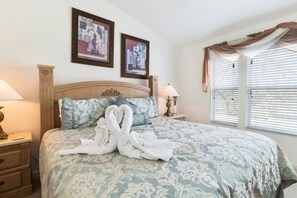 Elegant master bedroom with soft bedding and a serene atmosphere for a restful sleep.