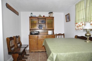 Cottage Kitchen with a small table that seats 4 to 5 persons.