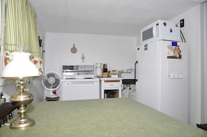 Cottage Kitchen with full size electric range, and full size refrigerator.