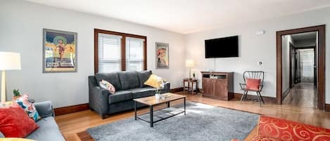 Large, living area with ample seating and pull-out couch (queen). Smart TV