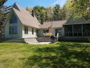 Patio and screened in porch which face the water.