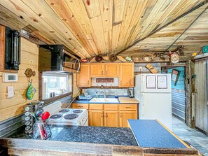 Full kitchen with pots, pans, dishes, linens