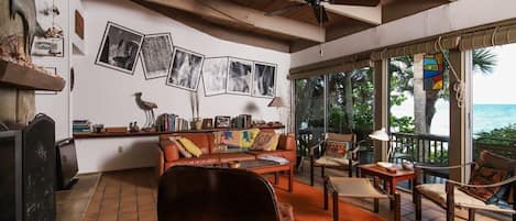 Family room/dinning room with wood-burning fireplace opens to front deck. 