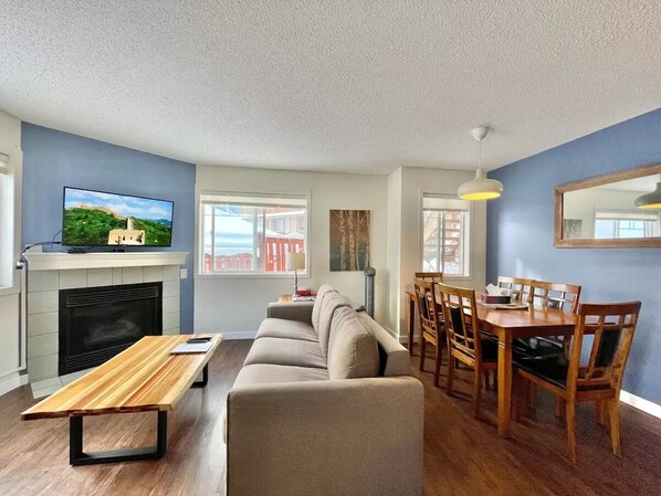 Living room with TV (Shaw cable, Roku, Netflix, Disney, Youtube) and sofa bed