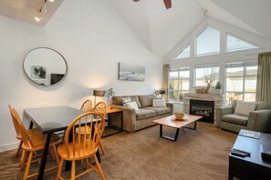 Living Room - Cozy fireplace, SmartTV, large vaulted ceilings, comfortable sofa and lounge chair.