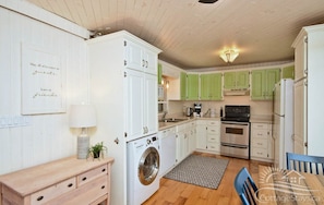 The fully-equipped kitchen is pretty and practical with full-size appliances.
