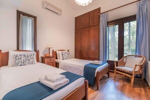 Second Bedroom – Two Comfortable Single Beds
Spacious and bright with a calm, minimal style and outdoor access.