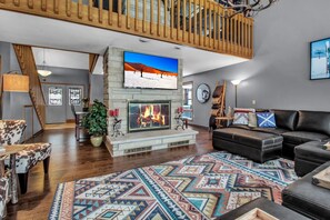 Family room with large screen TV, gas fireplace and radiant floor heat