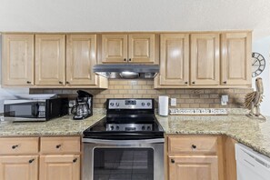 Full size kitchen including stove/oven, coffee maker, dishwasher, and microwave.