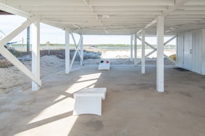 The perfect area under the bungalow for playing corn hole with views of the water and beach.