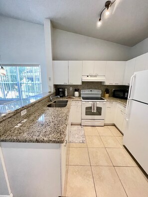 Equipped kitchen with granite countertops
