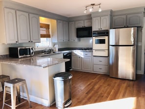 Large, open kitchen with stainless appliances
