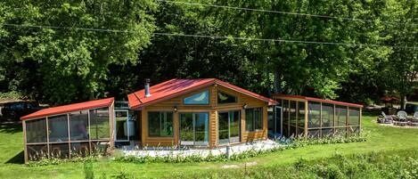 Drone shot showing both screen porches.  Hot tub in one, dining in the other.  