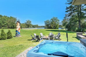 Hot tub and fire pit adjacent to screened in veranda 