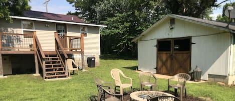 Backyard area, fire pit and out building sitting area.