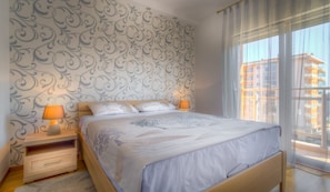 The bedroom opens to a small balcony and offers super comfortable king size bed