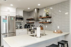 Experience culinary charm in this cozy kitchen, where efficiency meets elegance