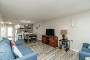Cheerful living area featuring ample seating, perfect for family gatherings and relaxation