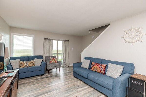 Spacious and sunny living area designed for family enjoyment, with plenty of seating available