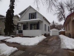 Front of house, driveway and single car garage