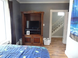 Master bedroom with queen bed and tv