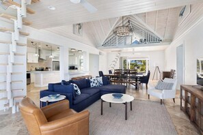 Living area with sofas, dining area with ocean views