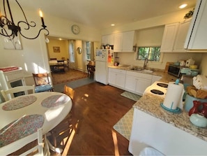 Walking in front door into kitchen, looking through to dining room