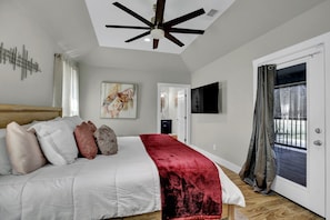 The master bedroom features a king size bed, Smart TV, luxurious en-suite bathroom and access to the deck, where a relaxing hot tub awaits.