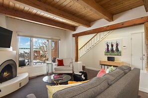 Living area with kiva fireplace, piano and smart TV