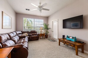 Family room retreat! Leather sectional recliner & wall-mounted HD TV.