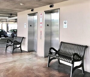 Elevator within gated parking lot.