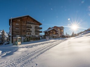 Sky, Building, Snow, House, Cloud, Slope, Street Light, Window, Tree, Mountain