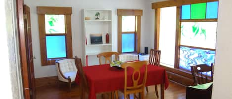 Beautiful colored glass dining room with writing desk. 