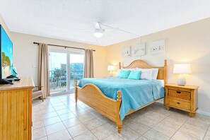 A charming bedroom with king size bed, soft hues and a balcony walkout