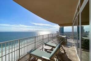 Lounger Chairs, 6-top dining, and a view for miles down the beach.