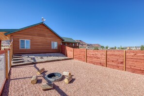 New fenced in private yard with wood burning fire pit.