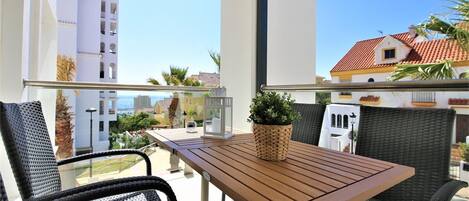 Balcony with partial sea views and extra dining area with seating for four