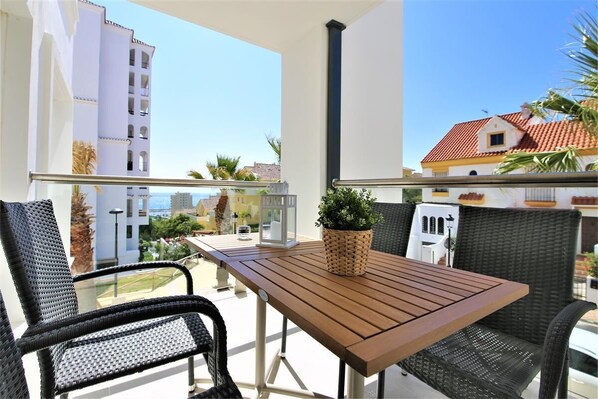 Balcony with partial sea views and extra dining area with seating for four