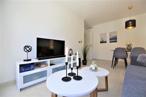 Modern lounge with air conditioning, international TV channels and balcony access