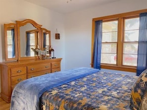 Bedroom 1 with Queen bed and dresser on the main level