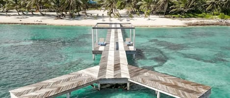 Secluded Waterfront Oasis! Nestled along the villa's shoreline, the dock provides a secluded escape for contemplation, where the gentle lapping of the waves serves as a soothing soundtrack to your moments of relaxation.
