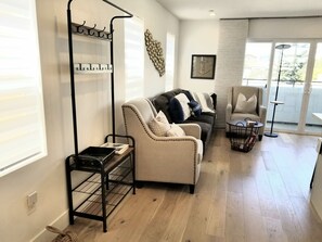 Roomy living space with wood floors throughout